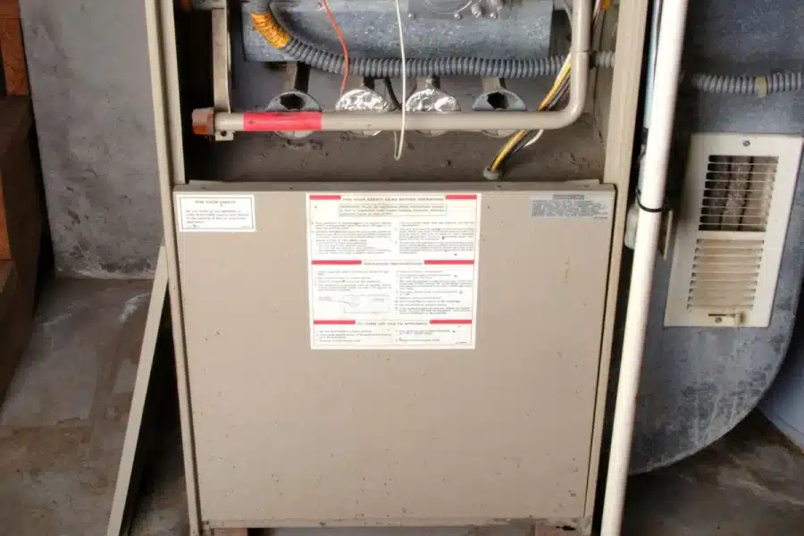 A furnace leaking water in a basement.