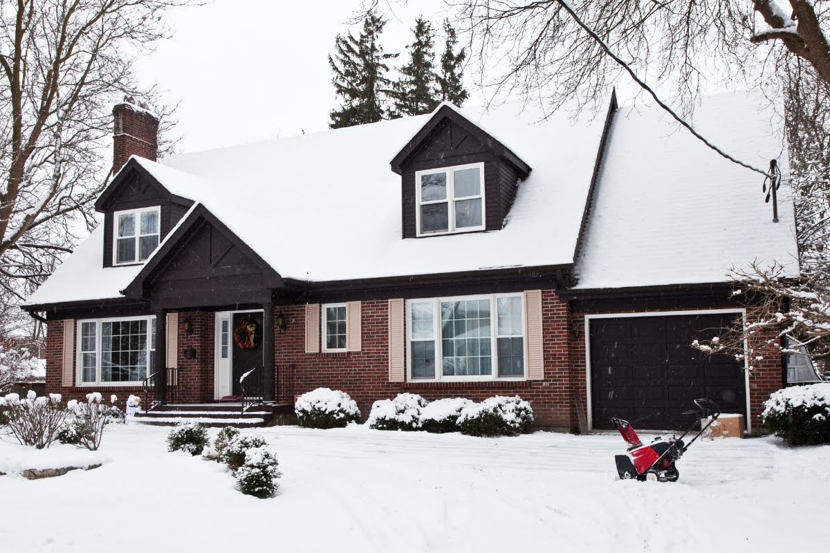 A home covered in snow in the winter.